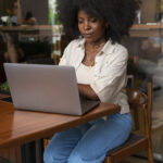 side-view-woman-reading-laptop